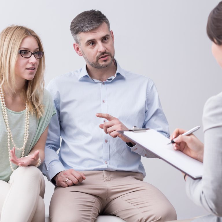 Couple speaking with a therapist during a session in a clinic