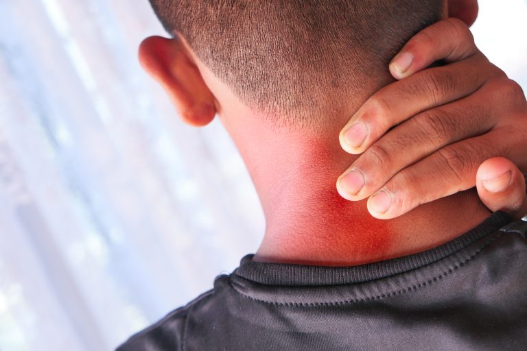 Trigger Point Therapy Camrose 2 Man holding his neck due to neck pain before visiting a physiotherapy clinic